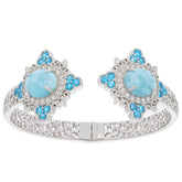 Oval blue Larimar Pectolite sterling silver bracelet with topaz accents, showcasing intricate design and luxury.